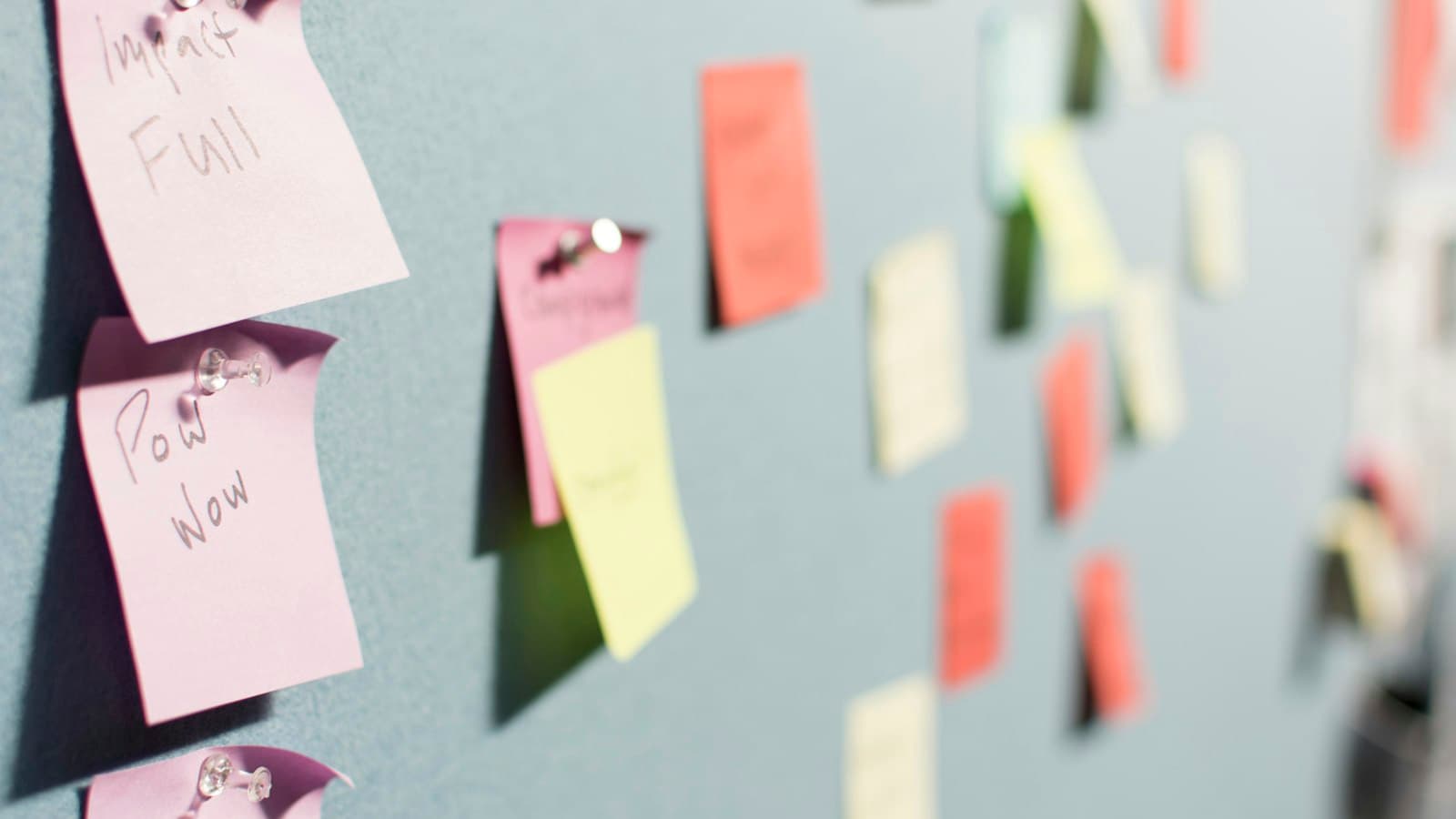 Handwritten sticky notes pinned to a noticeboard, the nearest reading “Impact Full”