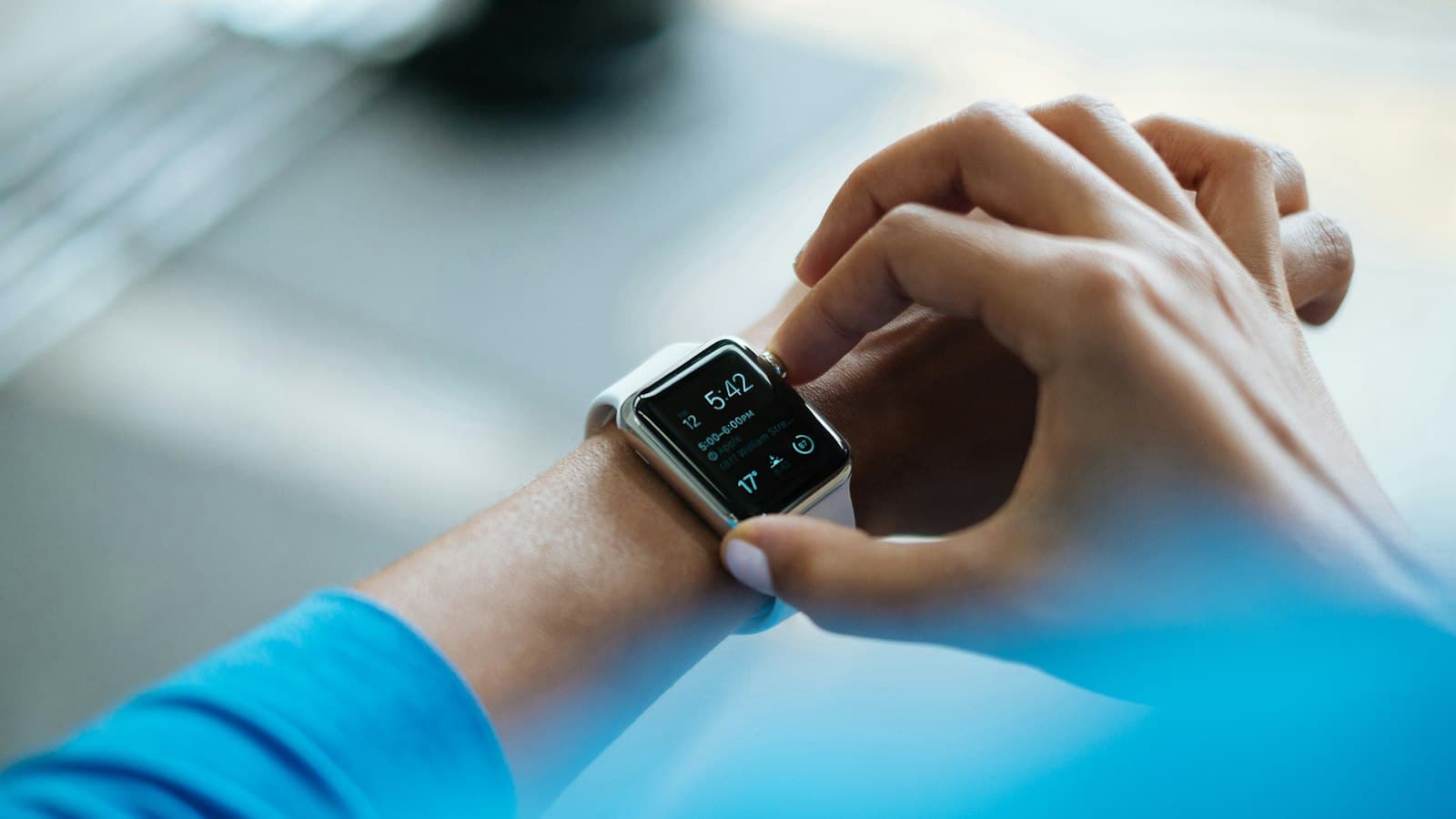 Close-up of a person checking the time on a smartwatch