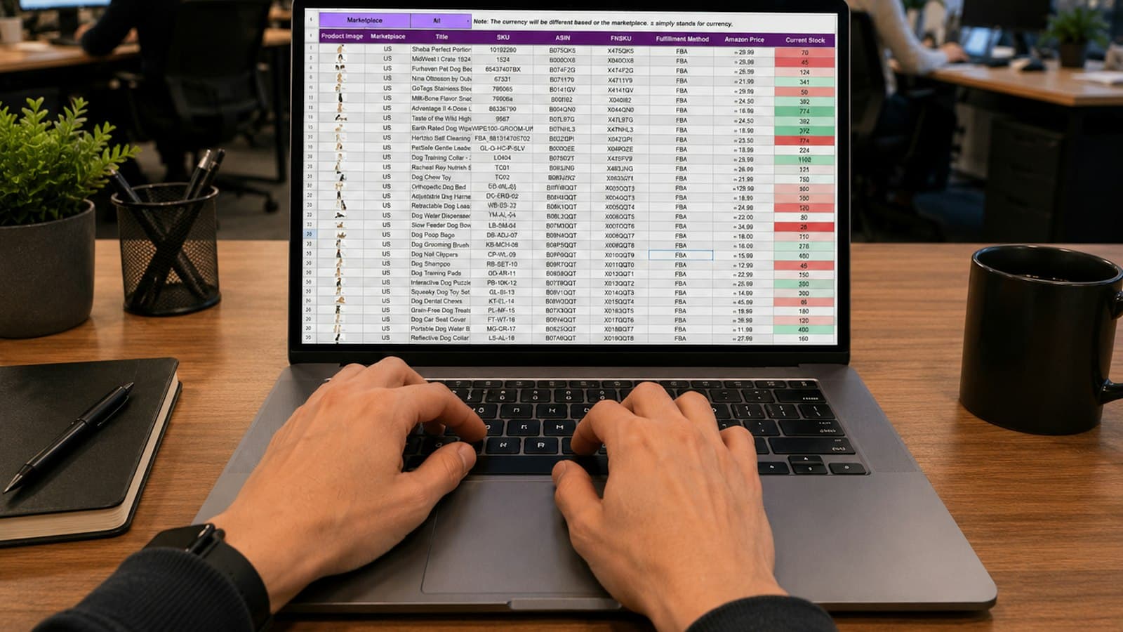 Hands typing on a laptop showing a data spreadsheet at an office desk