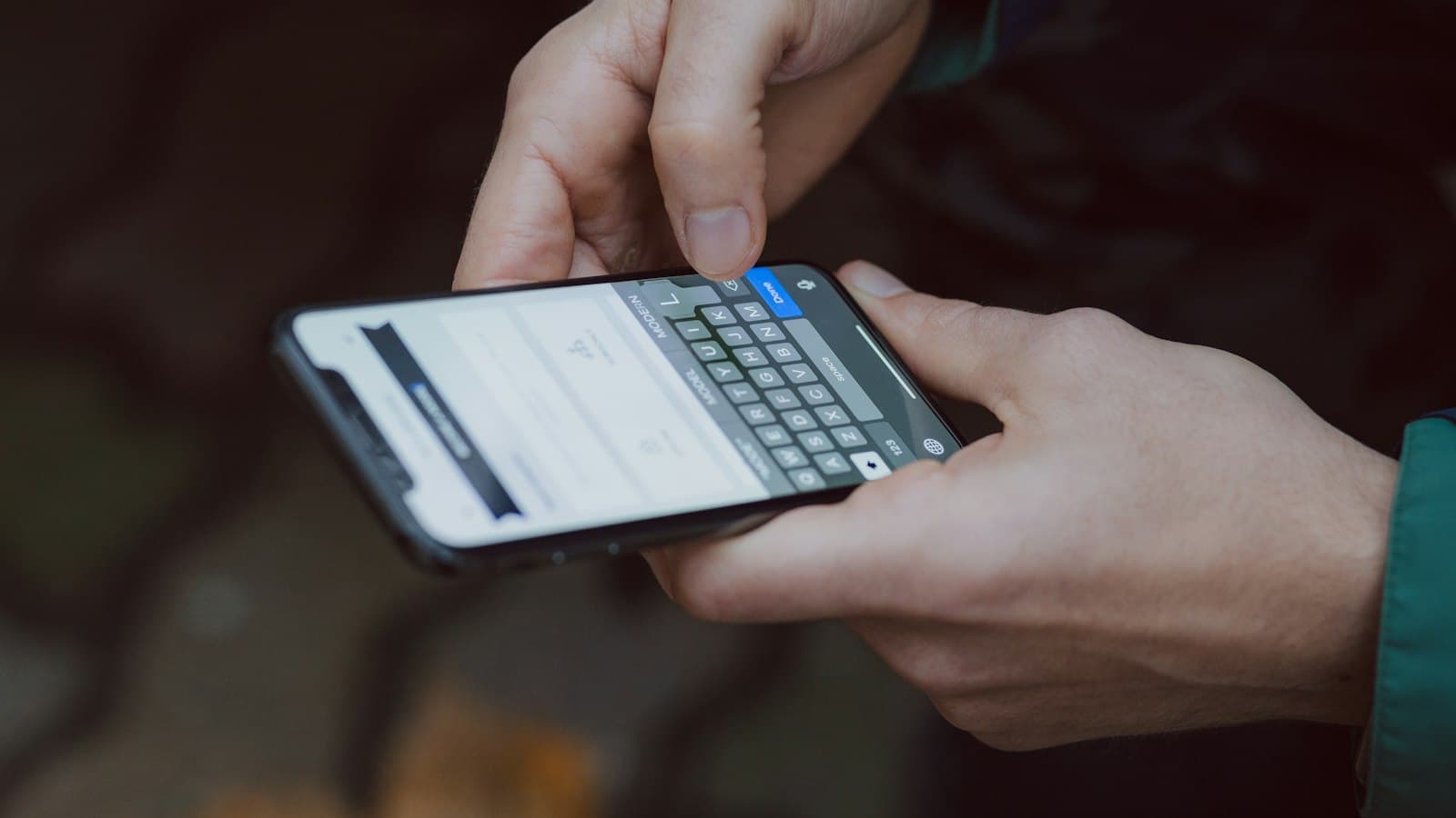 Close-up of someone typing their details into a form on a phone