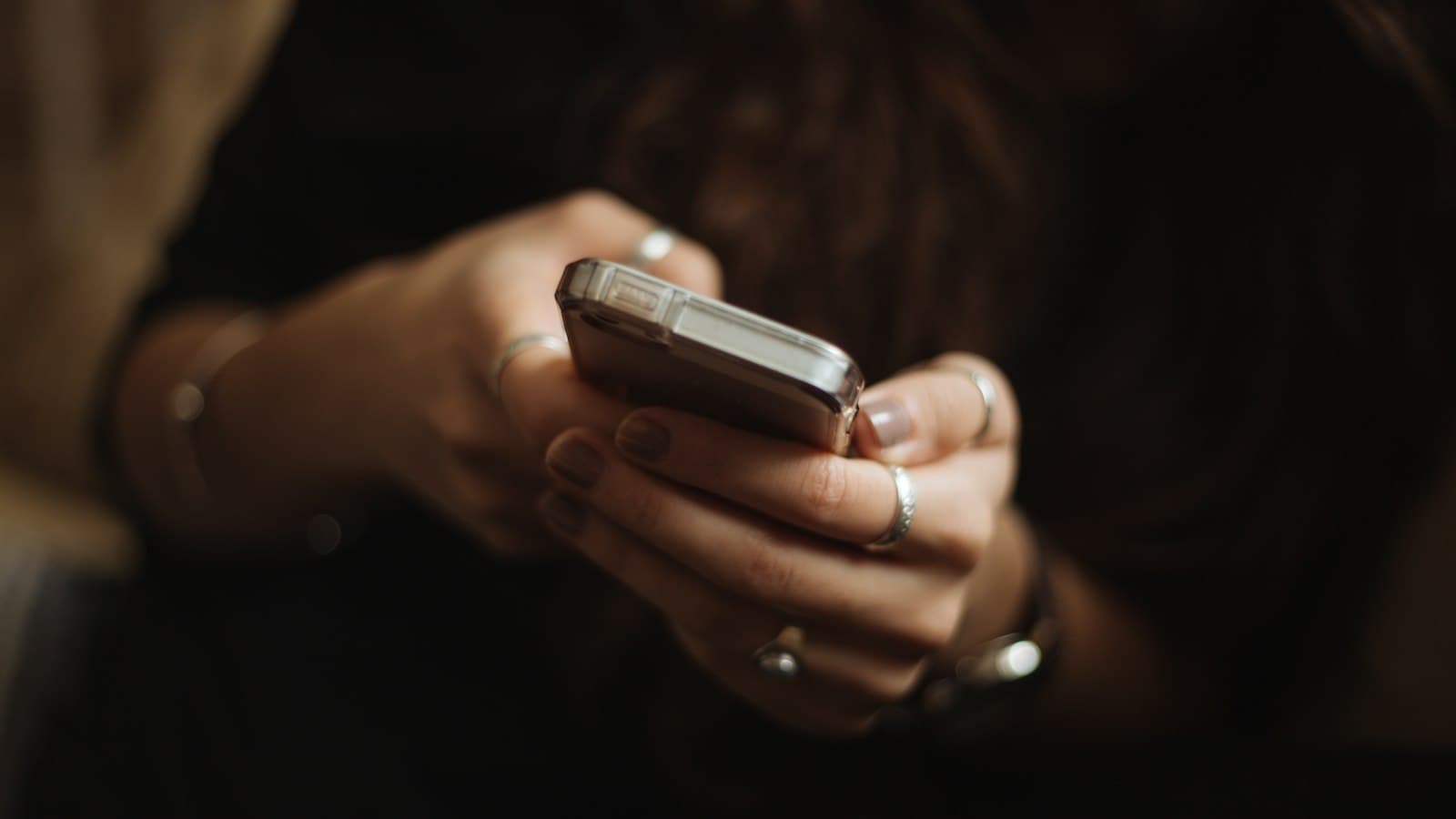 Close-up of hands tapping on a smartphone screen