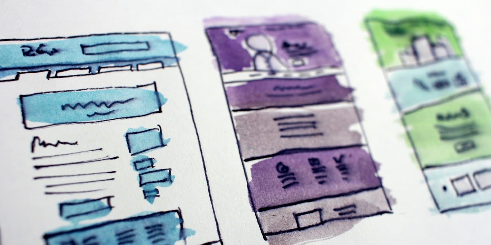 Hand-drawn watercolour wireframes of website page layouts