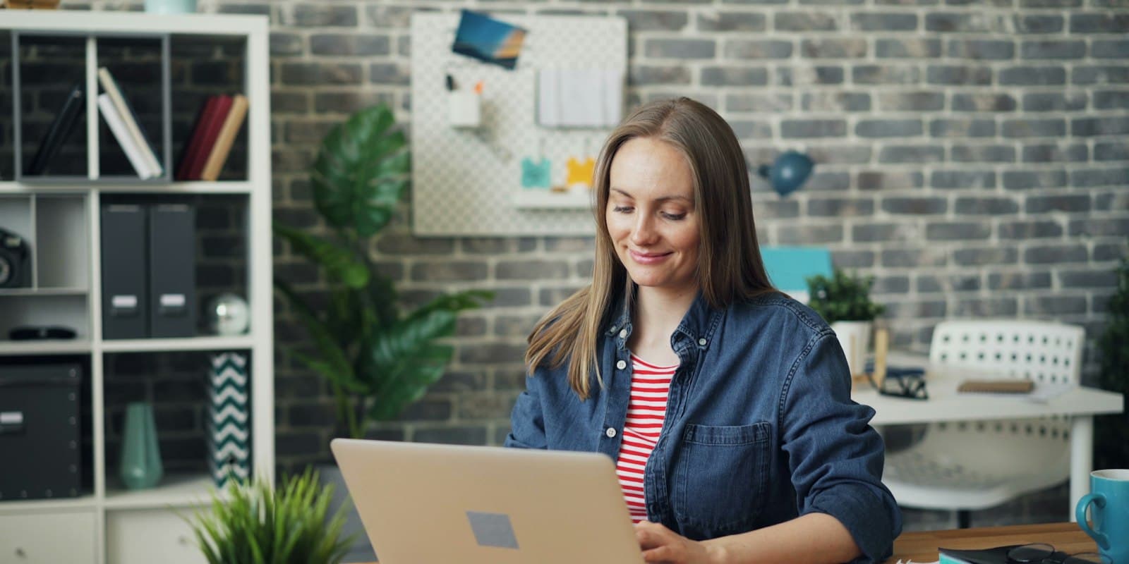 Founder setting up a workspace on a laptop in a bright office