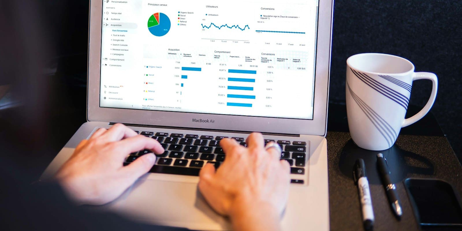 Manager reviewing dashboards and charts on a laptop