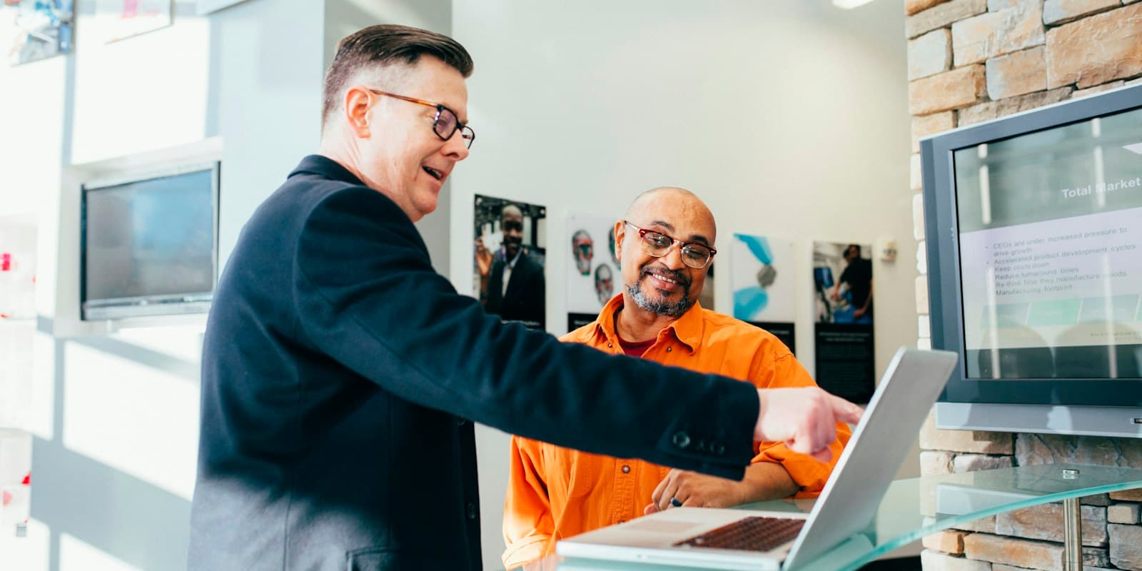 A salesperson greeting a client at their office desk